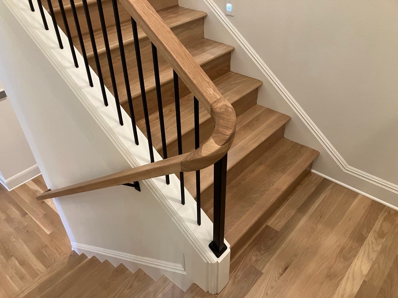 Hand-sculpted continuous white-oak handrail — Stumptown Stairs woodwork, Portland, OR
