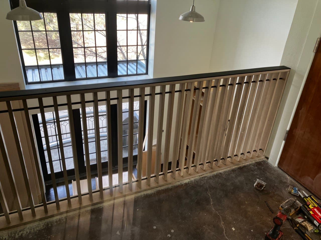 Detail of a white oak slat guardrail with black steel cap rail, Portland, OR