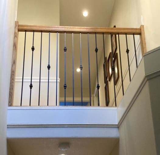 Loft railing with black metal balusters and wood cap rail — Stumptown Stairs, Portland, OR