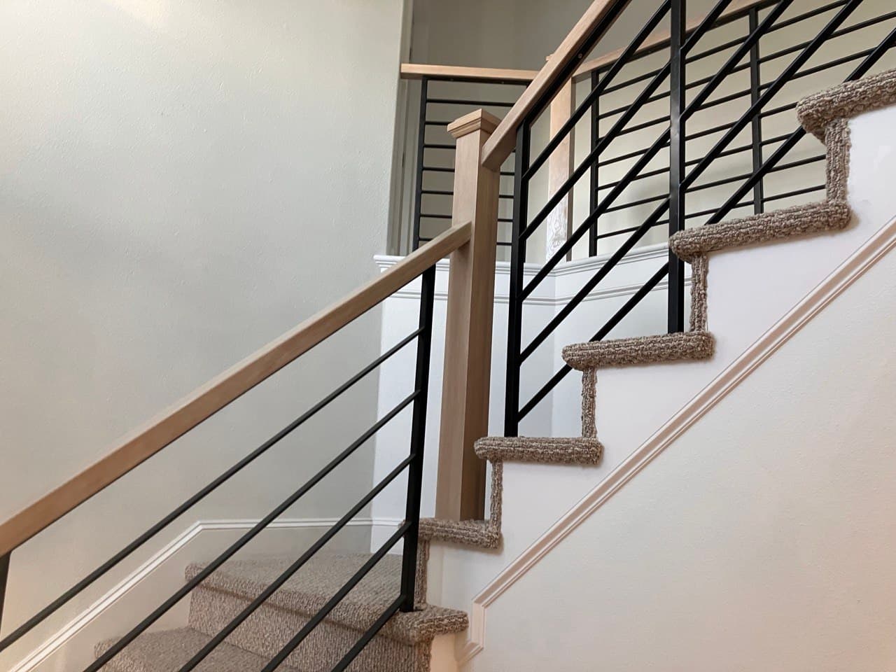 Railing detail — horizontal black steel balustrade with white oak handrail, Stumptown Stairs, Portland, OR
