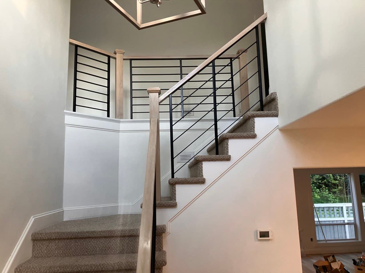 Modern staircase with horizontal black steel railing and white oak posts — Stumptown Stairs, Portland, OR