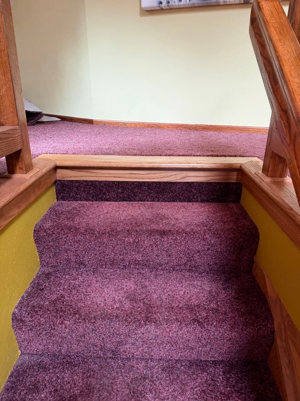 Carpeted staircase with oak newel posts and railing in a Portland home