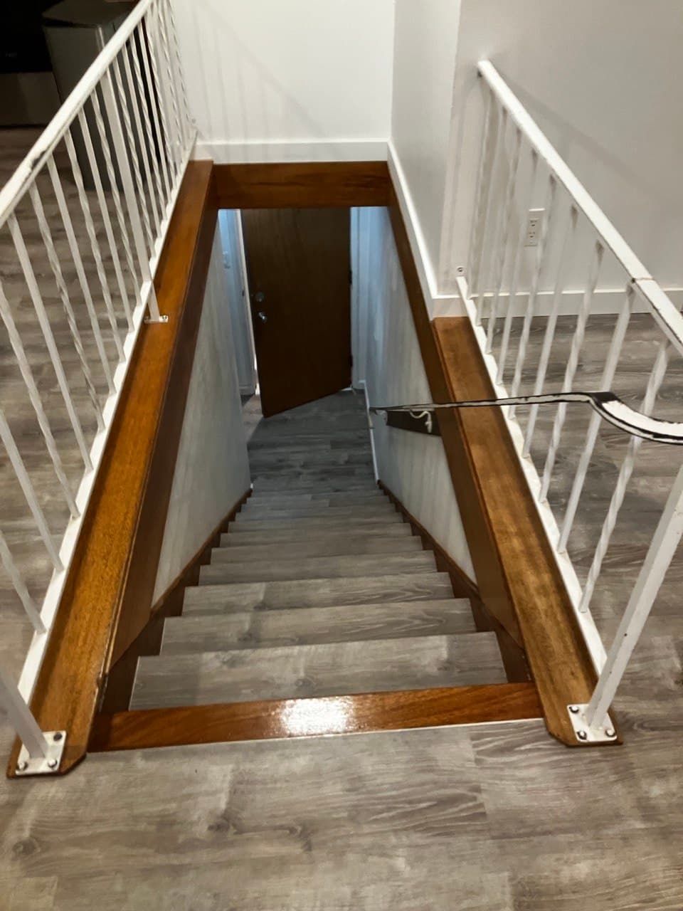 Refinished staircase with white balusters and stained wood cap railing, Portland