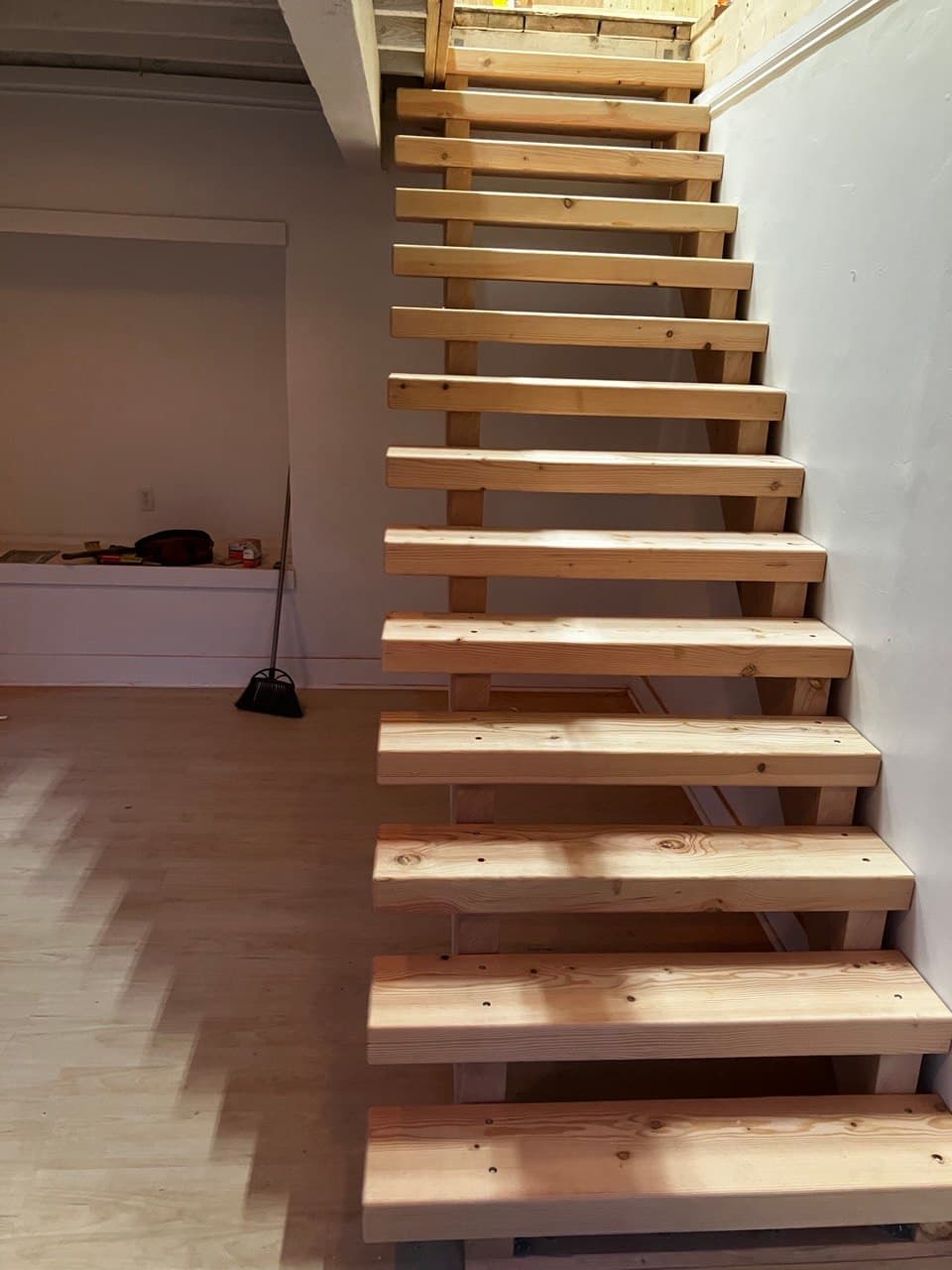 Open-riser staircase construction in a Portland basement by Stumptown Stairs