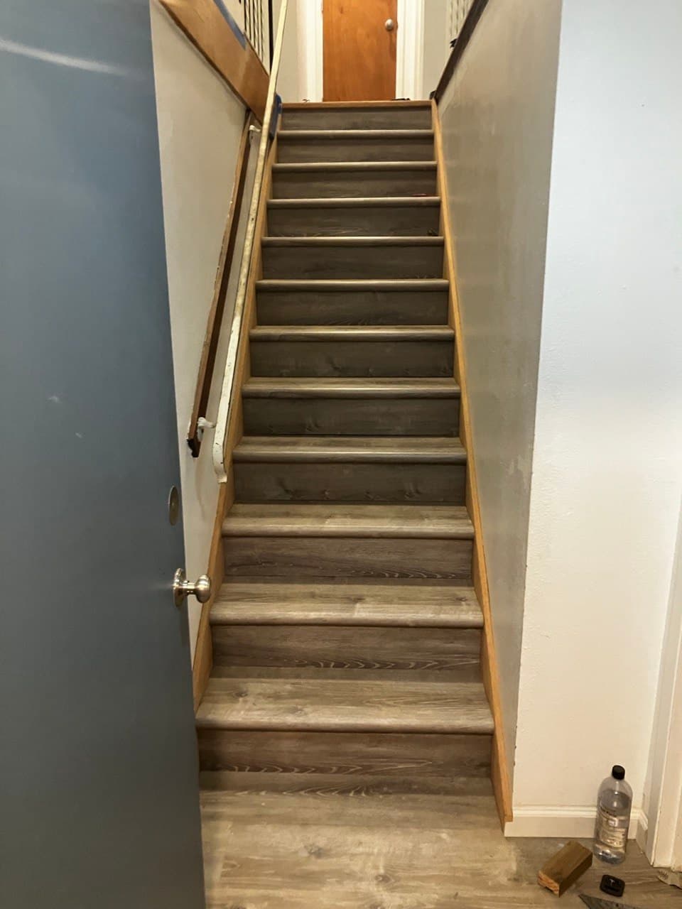 Straight staircase with gray treads and oak trim in a Portland home