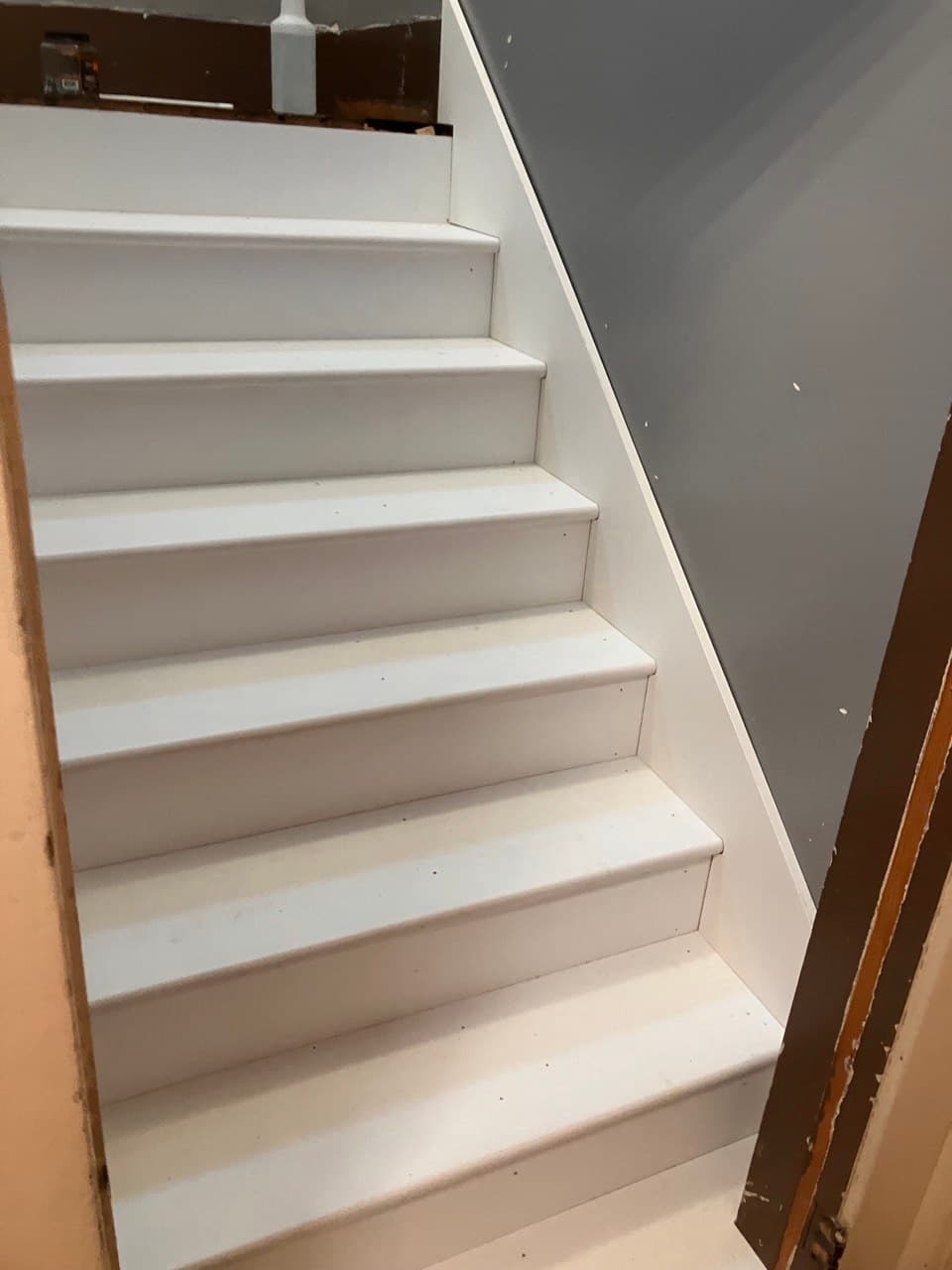 Staircase remodel with white-painted risers and wood trim, Portland
