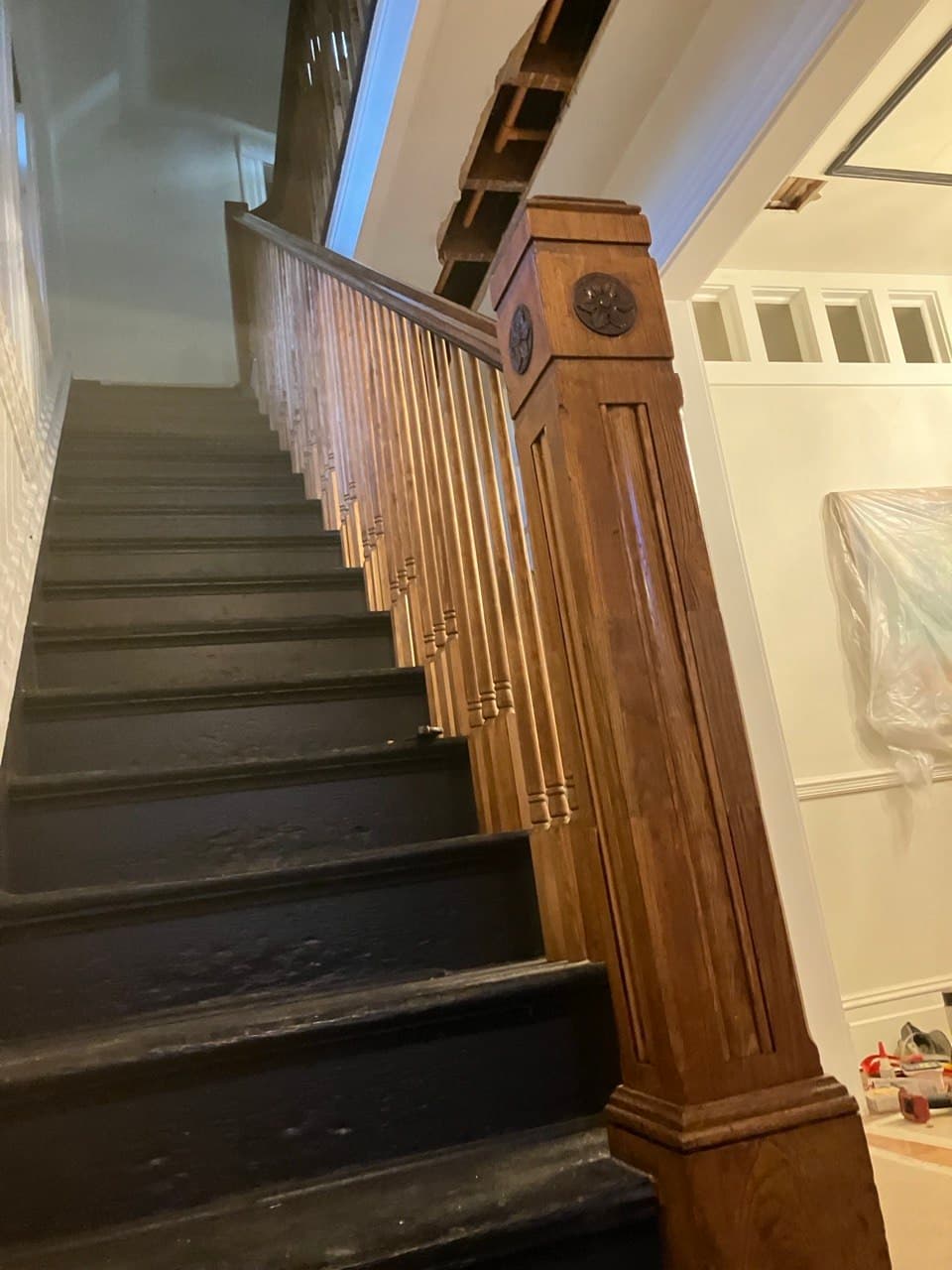 Historic craftsman staircase with ornate newel post restored in Portland