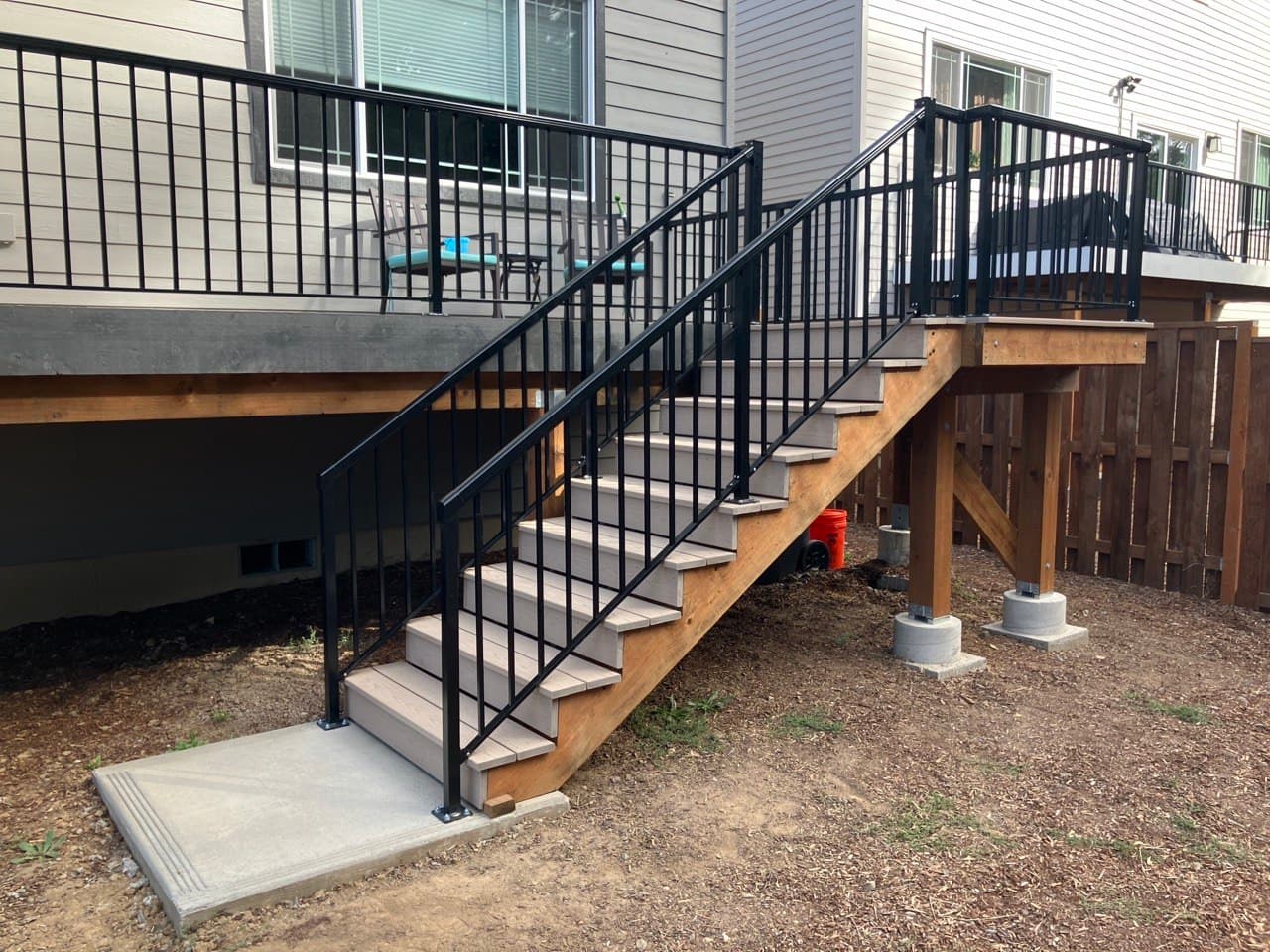 Exterior deck stairs with black metal railing built by Stumptown Stairs in Portland