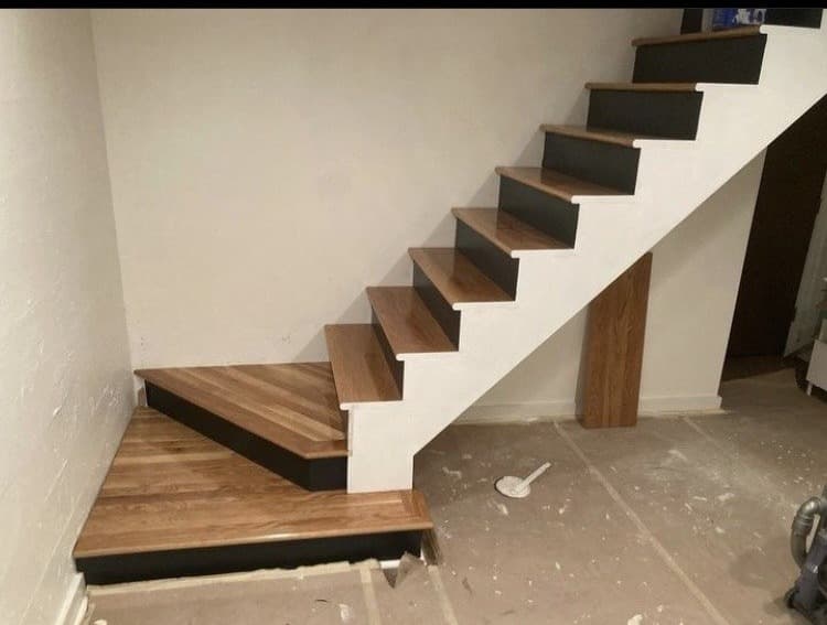 Basement staircase with wood treads and black risers built by Stumptown Stairs