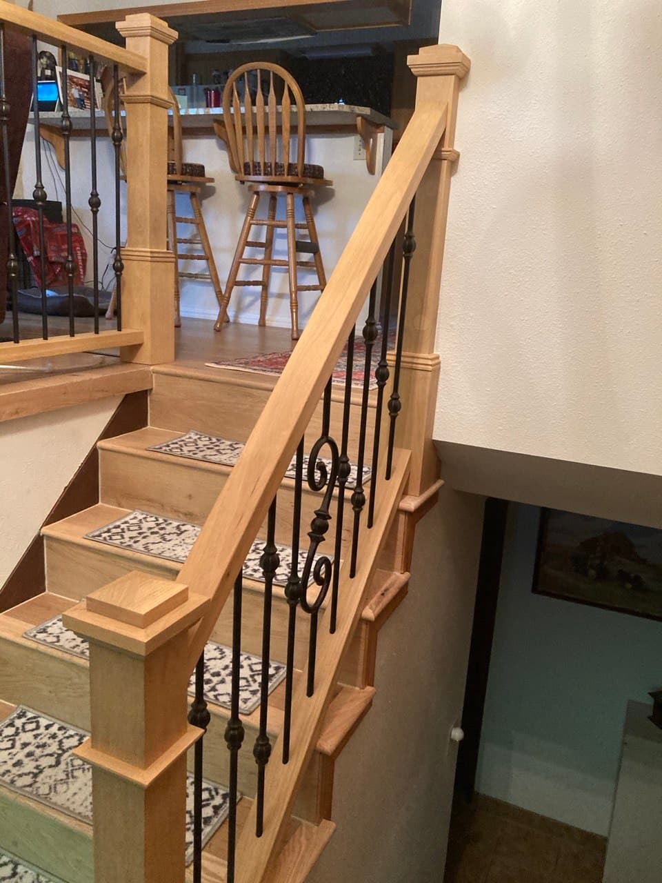 Oak staircase with decorative iron balusters crafted in Portland