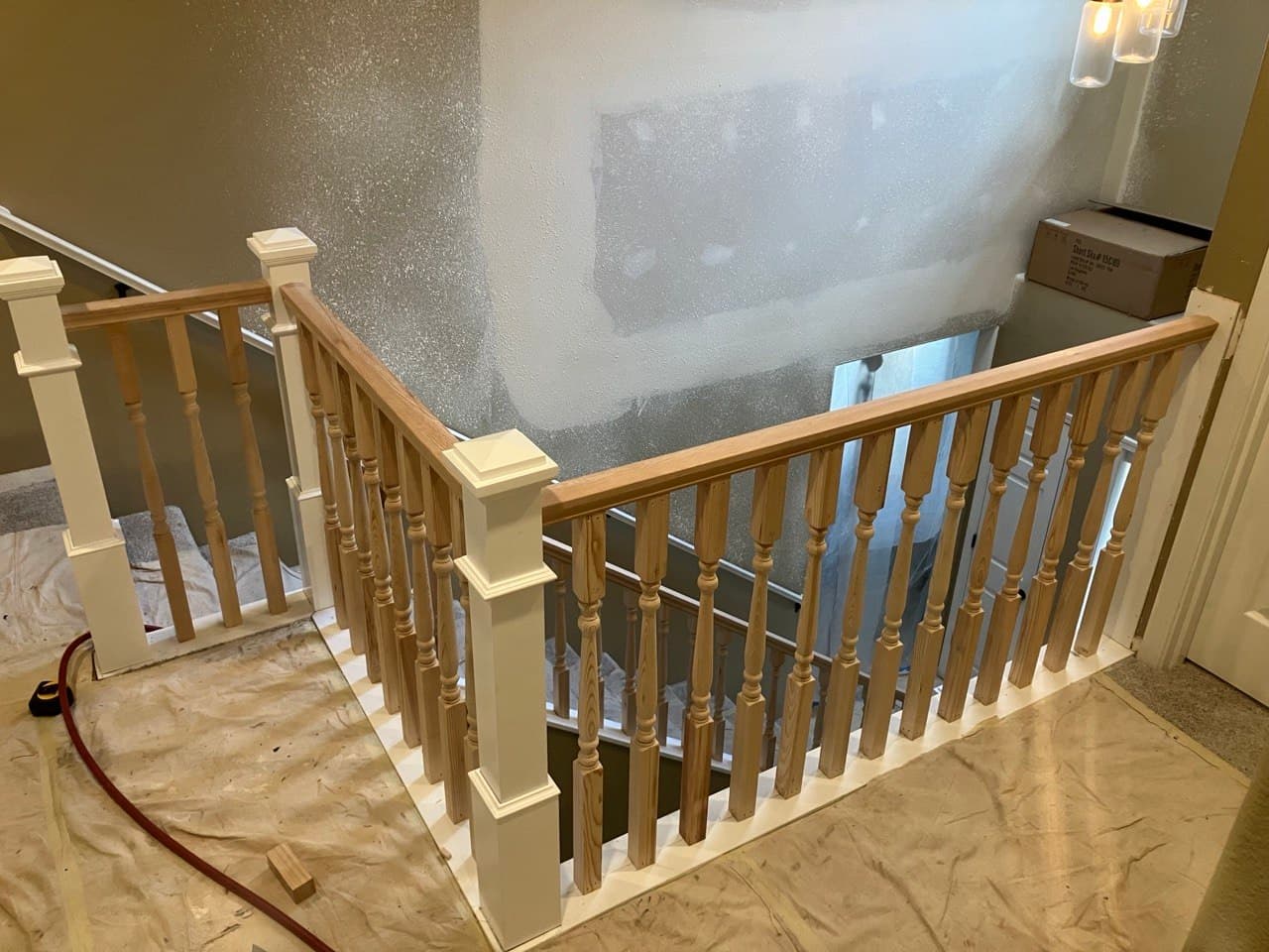 Turned-baluster guardrail on a staircase landing, Portland remodel