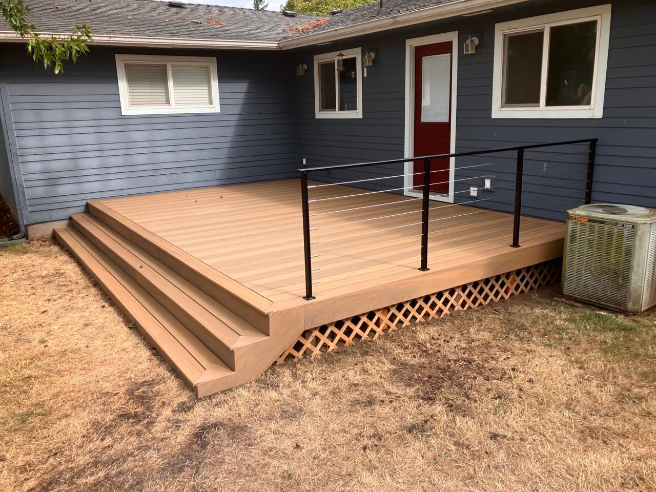 Composite deck and steps with black railing built by Stumptown Stairs, Portland