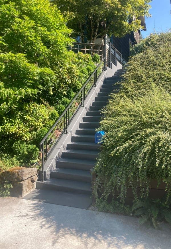 Long exterior staircase with black metal railing at a commercial-scale property — Stumptown Stairs, Portland, OR