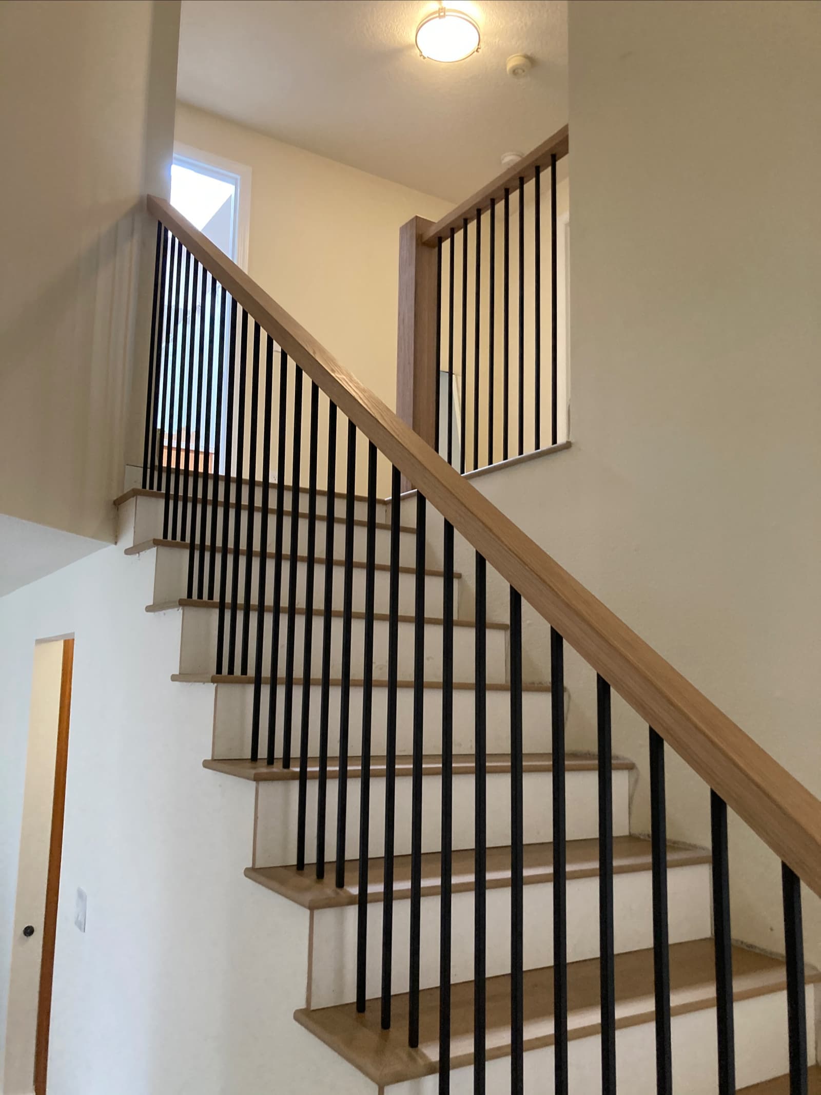 Wood handrail over welded steel balusters on a Portland staircase